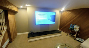 A remodeled basement with a TV.