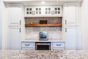 A white kitchen countertop and white cabinets.