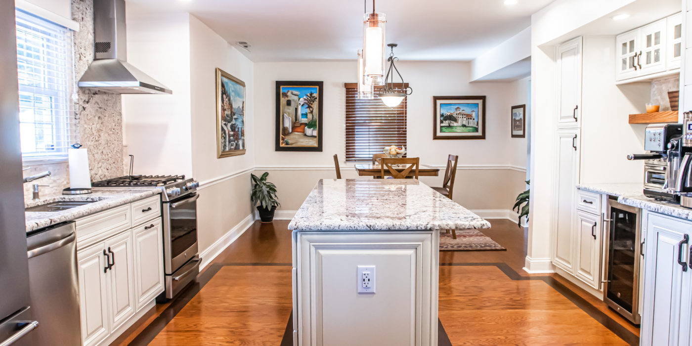 A kitchen with a white countertop and cabinets.