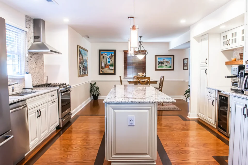 A kitchen with a white countertop and cabinets.