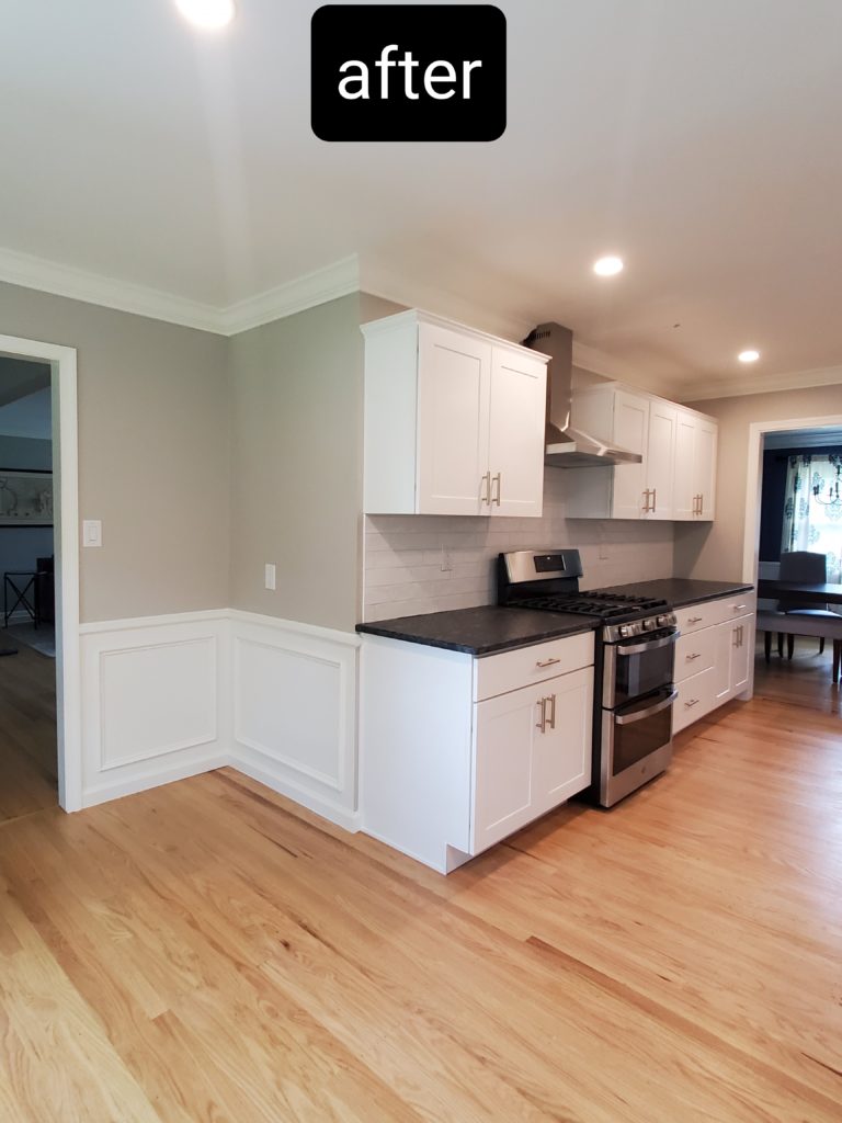 A kitchen redesigned to be much more spacious with new white cabinets and a stone countertop
