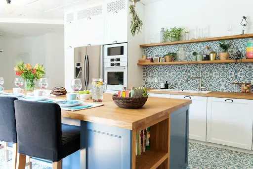 A modern kitchen with bold yet subdued colors and island.