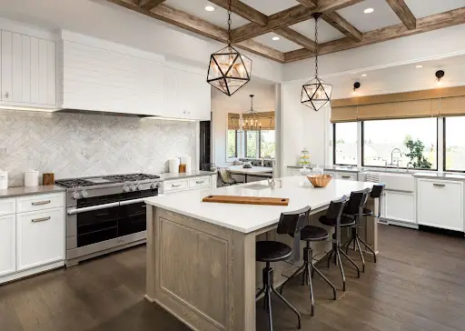 A beautifully redesigned kitchen with hardwood floor and island.