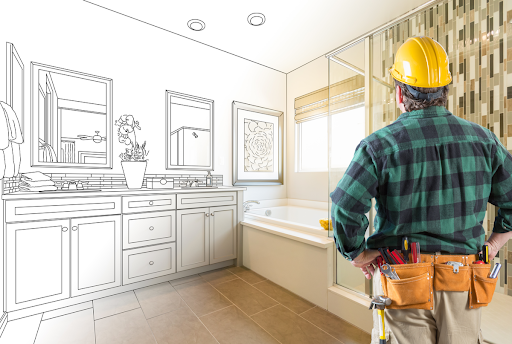 A man with a yellow hardhat stares at a bathroom image that is partially blue prints as he dreams of his new bathroom.